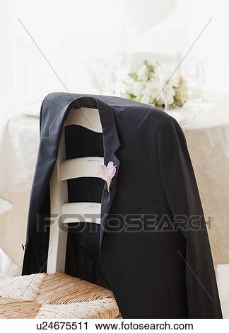 Stock Image - "Grooms suit jacket on chair at wedding, studio shot". Fotosearch