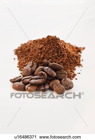 Stock Image - Heap of coffee beans and ground coffee. Fotosearch