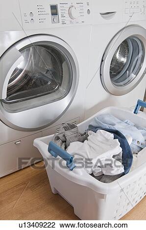 Laundry in basket in launderette View Large Photo Image Stock Image - Laundry in basket in launderette. Fotosearch