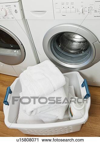 Laundry in basket in launderette View Large Photo Image Stock Image - Laundry in basket in launderette. Fotosearch