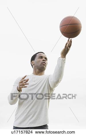 "Man playing with basketball, studio shot" View Large Photo Image Picture - "Man playing with basketball, studio shot". Fotosearch
