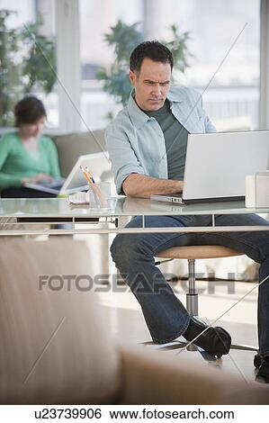 Man using laptop View Large Photo Image Stock Photograph - Man using laptop. Fotosearch