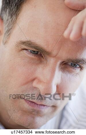 Picture - "Mature businessman contemplating, close-up". Fotosearch