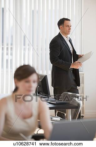 Mature businesswoman and businessman working in office View Large Photo Image Stock Image - Mature businesswoman and businessman working in office. Fotosearch