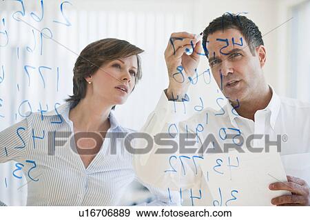 Stock Photo - Mature businesswoman and businessman making calculations. Fotosearch