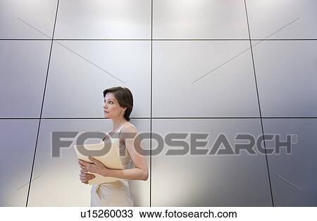 "Mature businesswoman holding document, low angle view" View Large Photo Image Stock Image - "Mature businesswoman holding document, low angle view". Fotosearch