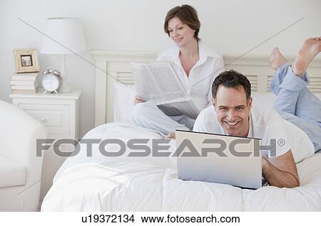 Mature couple in bed in the morning View Large Photo Image Picture - Mature couple in bed in the morning. Fotosearch