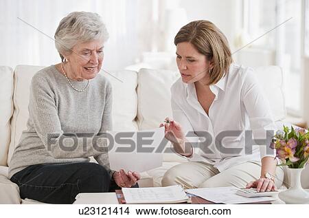 Mature woman giving financial advice to senior woman View Large Photo Image Picture - Mature woman giving financial advice to senior woman. Fotosearch
