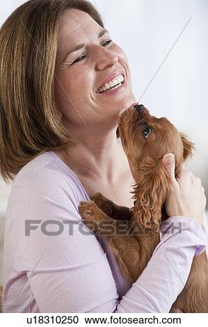 Mature woman hugging puppy View Large Photo Image Stock Image - Mature woman hugging puppy. Fotosearch