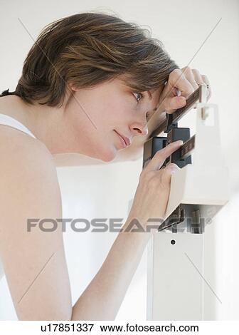 Stock Photo - Mature woman on scales. Fotosearch