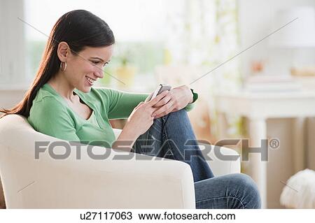 Mid-adult woman texting with mobile phone View Large Photo Image Stock Image - Mid-adult woman texting with mobile phone. Fotosearch