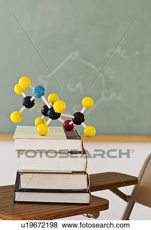 Stock Photo - Molecule model on stack of books. Fotosearch