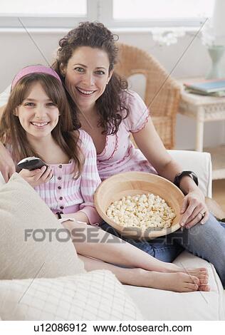 "Mother and daughter (10-12 years) watching TV, portrait" View Large Photo Image Stock Image - "Mother and daughter (10-12 years) watching TV, portrait". Fotosearch