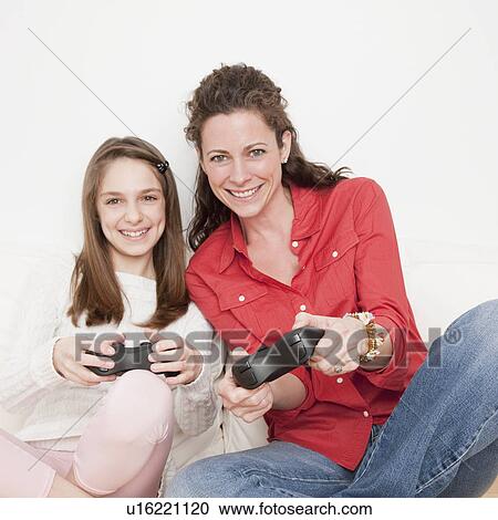 "Mother and daughter (10-12 years) playing video game, portrait" View Large Photo Image Stock Image - "Mother and daughter (10-12 years) playing video game, portrait". Fotosearch