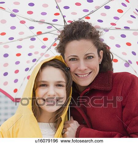 "Mother and daughter (10-12 years) under umbrella, portrait" View Large Photo Image Stock Photograph - "Mother and daughter (10-12 years) under umbrella, portrait". Fotosearch