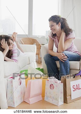 Mother and daughter (10-12 years) relaxing after shopping View Large Photo Image Stock Photograph - Mother and daughter (10-12 years) relaxing after shopping. Fotosearch