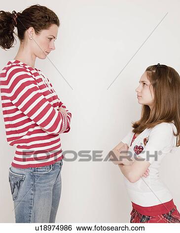 "Mother and daughter (10-12 years) having argument, standing face to face" View Large Photo Image Stock Photograph - "Mother and daughter (10-12 years) having argument, standing face to face". Fotosearch