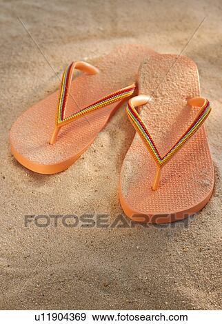 Pair of thongs on sand View Large Photo Image Stock Photo - Pair of thongs on sand. Fotosearch