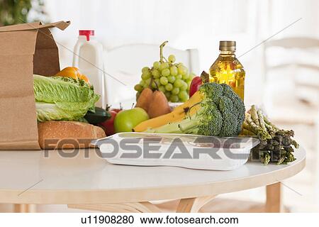 Paper bag filled with groceries View Large Photo Image Stock Image - Paper bag filled with groceries. Fotosearch