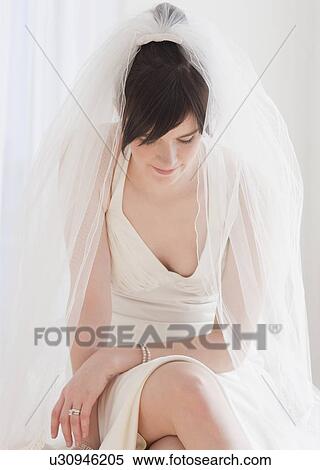 "Pensive bride in wedding dress, studio shot" View Large Photo Image Stock Photography - "Pensive bride in wedding dress, studio shot". Fotosearch