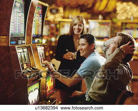 People in casino playing on slot machines View Large Photo Image Picture - People in casino playing on slot machines. Fotosearch