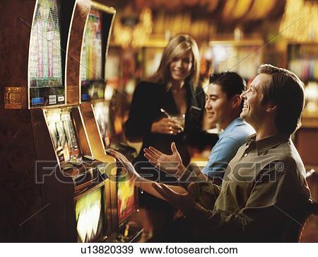 Stock Photo - "People in casino playing on slot machines, Las Vegas, Nevada, USA". Fotosearch