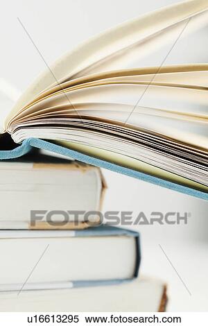 Stock Photography - "Pile of books with one open, studio shot". Fotosearch
