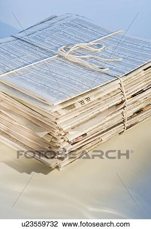 Stock Image - "Pile of newspapers for recycling, studio shot". Fotosearch