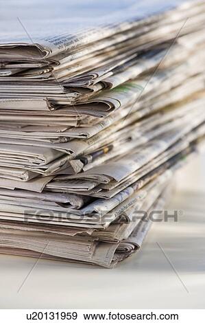 Stock Photo - "Pile of newspapers for recycling, studio shot". Fotosearch
