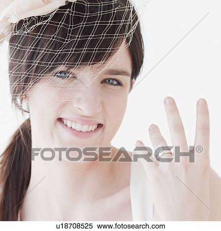 "Portrait of bride wearing wedding dress, showing ring" View Large Photo Image Stock Photography - "Portrait of bride wearing wedding dress, showing ring". Fotosearch