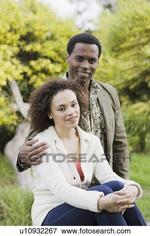 Stock Photo - Portrait of couple smiling in park. Fotosearch