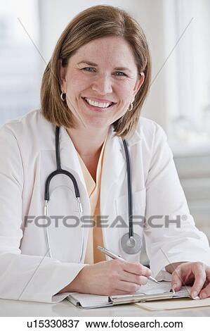Stock Photo - Portrait of female doctor in office. Fotosearch
