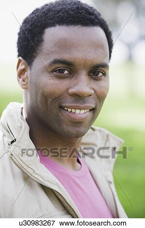 "Portrait of man smiling, outdoors" View Large Photo Image Stock Photo - "Portrait of man smiling, outdoors". Fotosearch