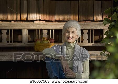 Portrait of senior woman relaxing outside home View Large Photo Image Stock Image - Portrait of senior woman relaxing outside home. Fotosearch