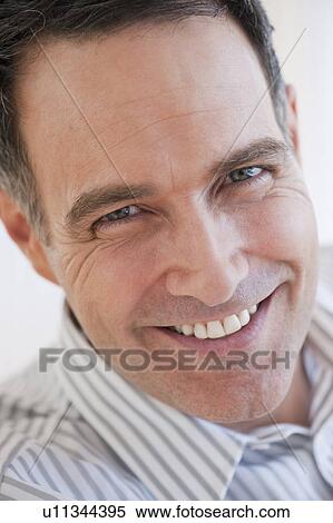 Stock Photography - Portrait of successful mature businessman smiling. Fotosearch