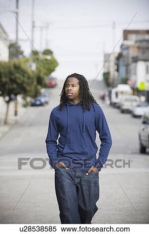 Stock Photography - "Portrait of teenage boy (16-17) walking in street, San Francisco, California, USA". Fotosearch