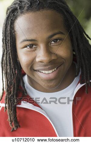 "Portrait of teenage boy (16-17) with dreadlocks, smiling" View Large Photo Image Stock Image - "Portrait of teenage boy (16-17) with dreadlocks, smiling". Fotosearch