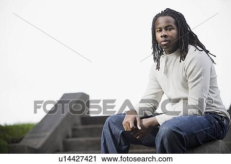 "Portrait of teenage boy (16-17) with dreadlocks, sitting on steps" View Large Photo Image Stock Image - "Portrait of teenage boy (16-17) with dreadlocks, sitting on steps". Fotosearch
