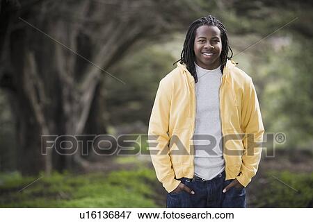 "Portrait of teenage boy (16-17) with dreadlocks, smiling in park" View Large Photo Image Stock Photo - "Portrait of teenage boy (16-17) with dreadlocks, smiling in park". Fotosearch
