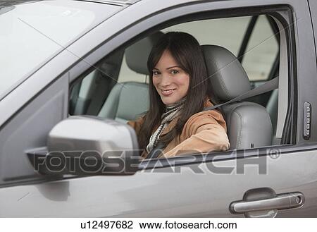 Portrait of woman driving car View Large Photo Image Stock Image - Portrait of woman driving car. Fotosearch