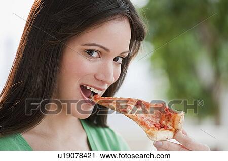 Portrait of woman eating pizza slice View Large Photo Image Stock Image - Portrait of woman eating pizza slice. Fotosearch