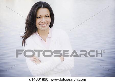 Portrait of woman smiling by sea View Large Photo Image Stock Image - Portrait of woman smiling by sea. Fotosearch