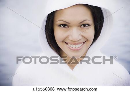Stock Photo - Portrait of woman smiling by sea. Fotosearch