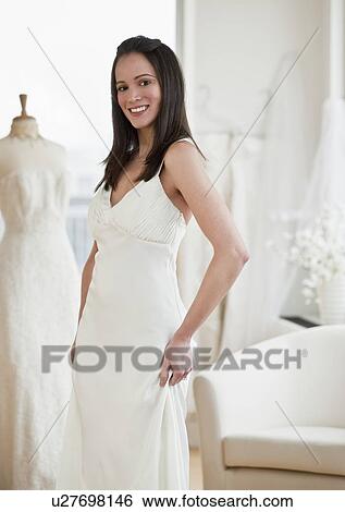 Portrait of woman trying on wedding dress View Large Photo Image Stock Photograph - Portrait of woman trying on wedding dress. Fotosearch