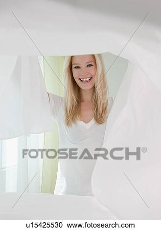Portrait of young woman making bed View Large Photo Image Stock Image - Portrait of young woman making bed. Fotosearch