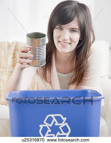 Portrait of young woman putting can in recycling bin View Large Photo Image Stock Image - Portrait of young woman putting can in recycling bin. Fotosearch
