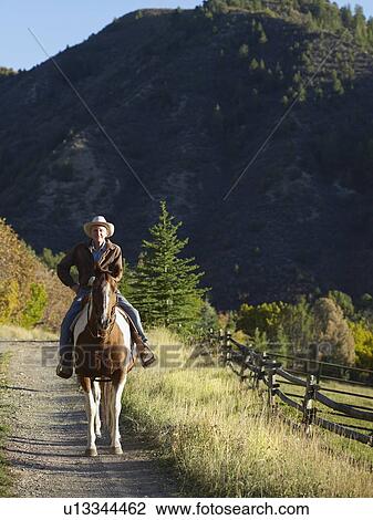 "Senior man horseback riding, Colorado, USA" View Large Photo Image Stock Image - "Senior man horseback riding, Colorado, USA". Fotosearch