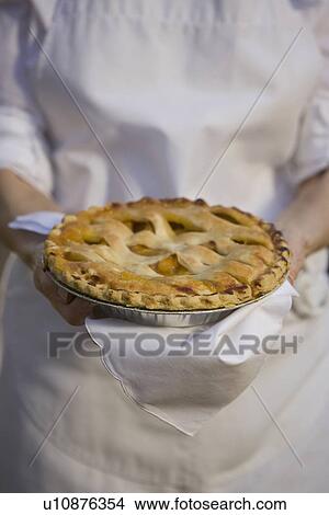 Picture - Senior woman holding freshly baked pie. Fotosearch