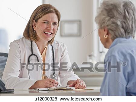 Senior woman talking with female doctor View Large Photo Image Stock Photo - Senior woman talking with female doctor. Fotosearch