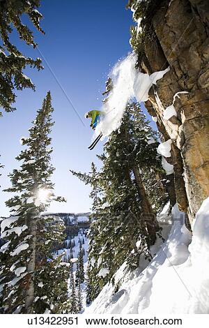 Stock Image - "Skier jumping off cliff Aspen Snowmass, Aspen, Colorado, USA ". Fotosearch